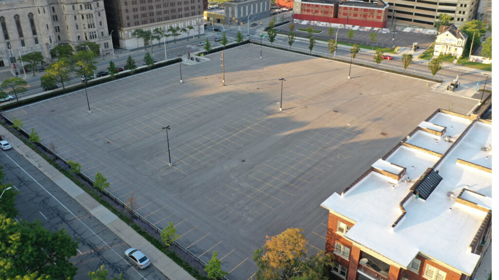 Aerial photograph of a large and completely empty parking lot in the lower Cass Corridor.